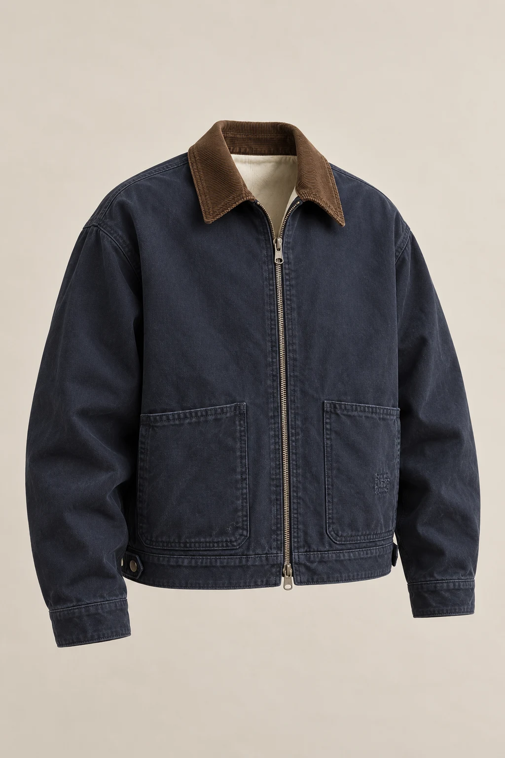 A navy canvas zip work jacket with a tobacco corduroy collar, two lower patch pockets and hem adjustment tabs.